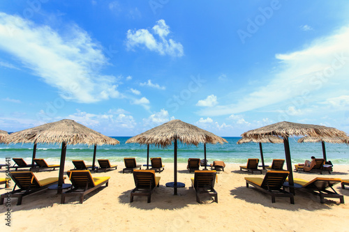 Sun umbrella and sun loungers stand at the beach in Phuket, Thai © SKT Studio