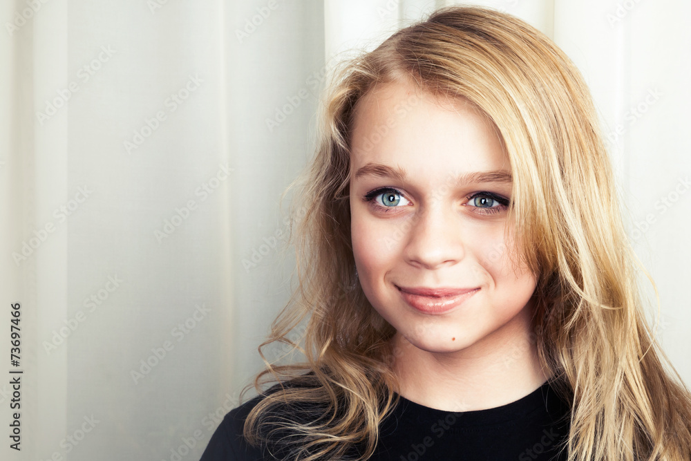 Smiling blond Caucasian girl, studio portrait Smiling blond Caucasian girl, studio portrait