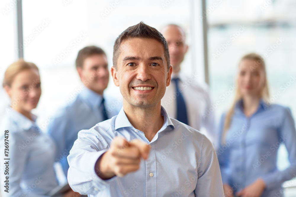 group of smiling businesspeople meeting in office group of smiling businesspeople meeting in office