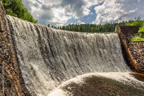 Mountain waterfall in summer