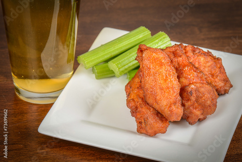 Chicken Buffalo Wings with Celery Sticks and Beer