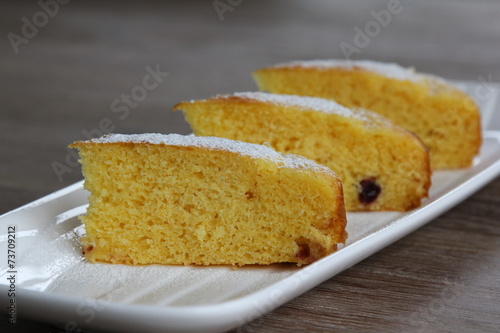 Yellow cake with cranberries topped with icing sugar