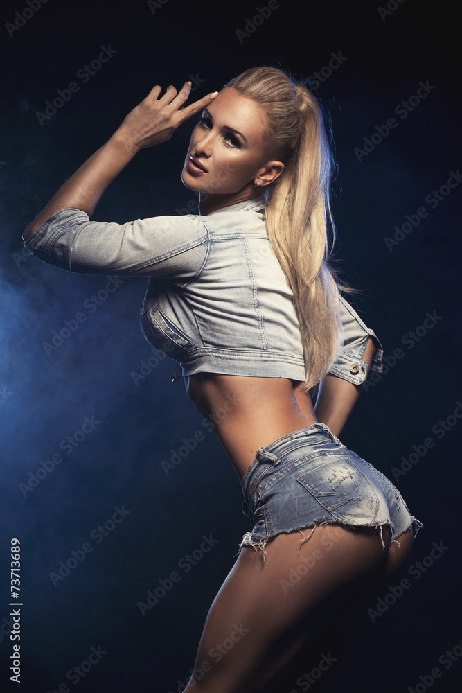 Backside od sexy blonde young woman posing in short jeans Stock Photo |  Adobe Stock