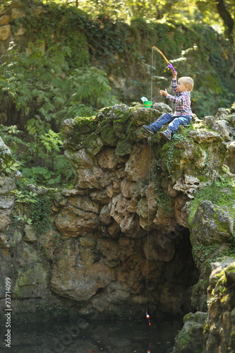 boy fishing in the autumn park