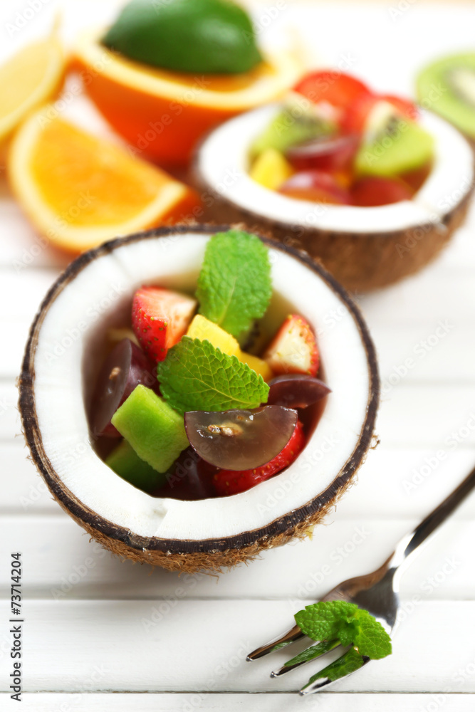 Fruit salad in coconut on table Fruit salad in coconut on table