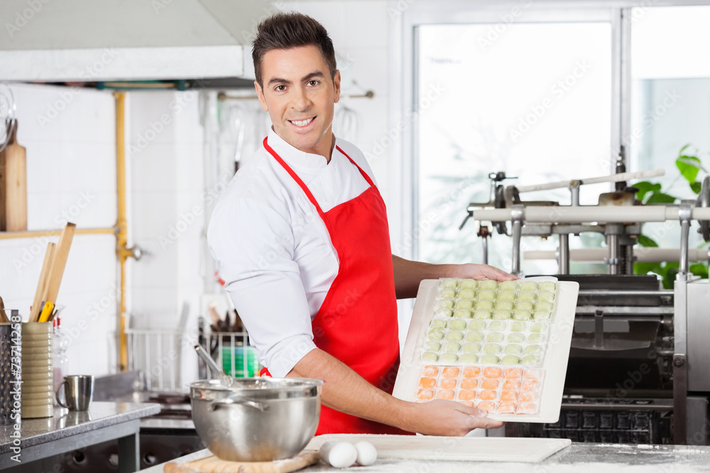 Confident Chef Presenting Raw Ravioli Pasta On Cutting Board Confident Chef Presenting Raw Ravioli Pasta On Cutting Board