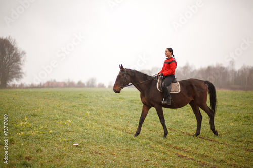Young woman riding a horse