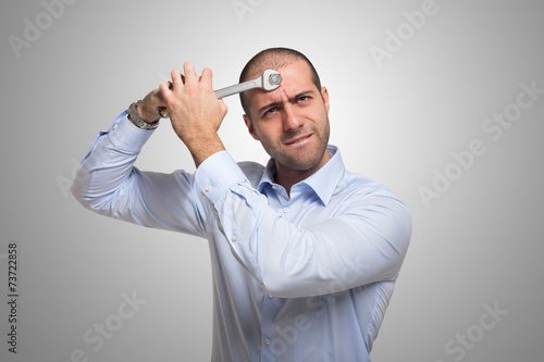 Man using a wrench to fix his brain