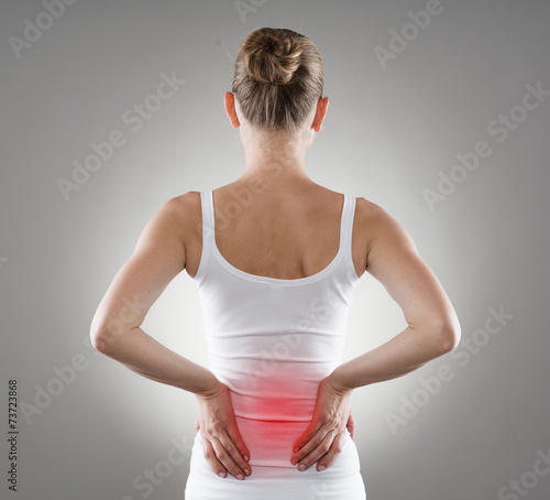 Loin spasm. Young woman with hurt backbone.