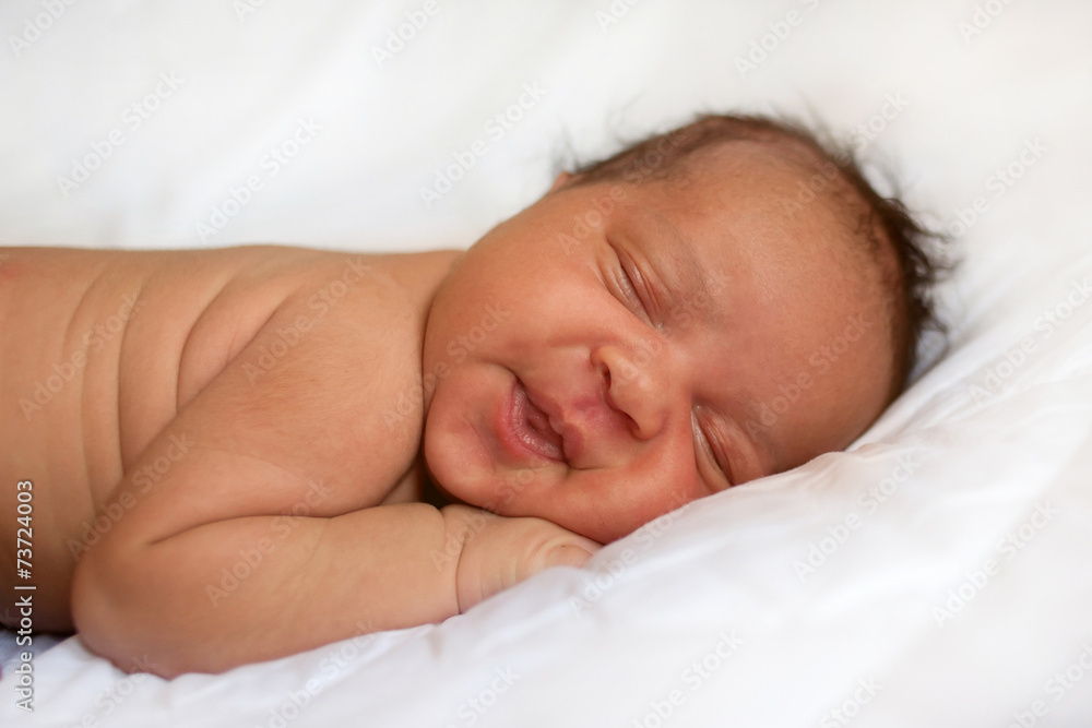 newborn baby girl sleeping. Black baby on white bed. newborn baby girl sleeping. Black baby on white bed.