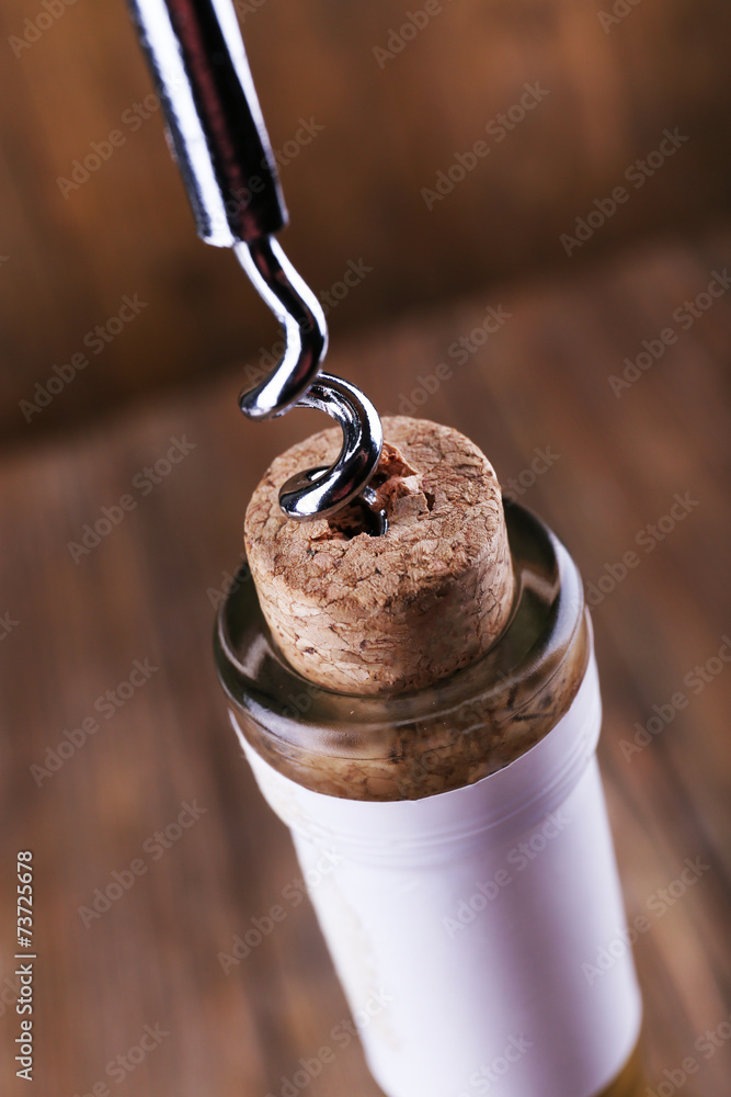 Bottle opener close-up, on wooden background Bottle opener close-up, on wooden background