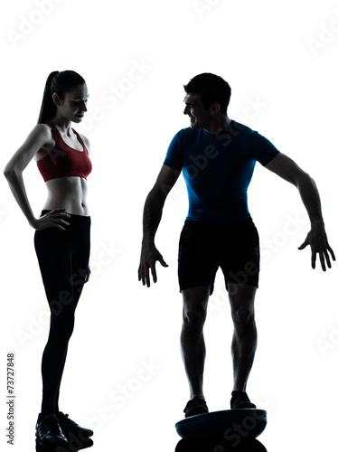 coach man woman exercising squats on bosu silhouette