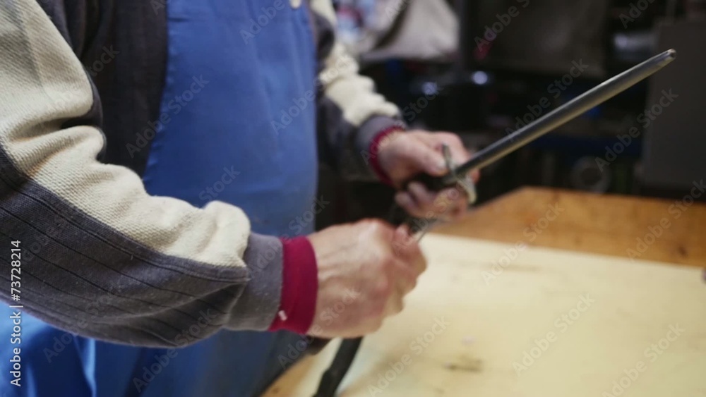 Old butcher sharpening his knife in slow motion Old butcher sharpening his knife in slow motion