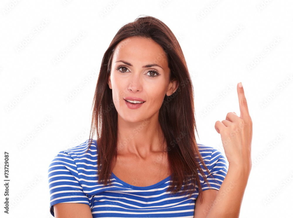 Smiling young woman with finger pointing up Smiling young woman with finger pointing up