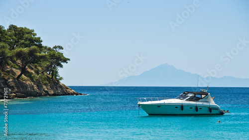 Boat anchored in a small bay at Thassos island © banepetkovic