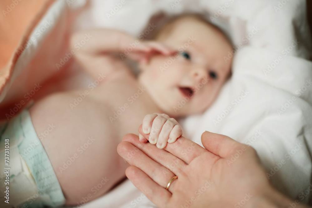 little baby keeps mom's fingers
