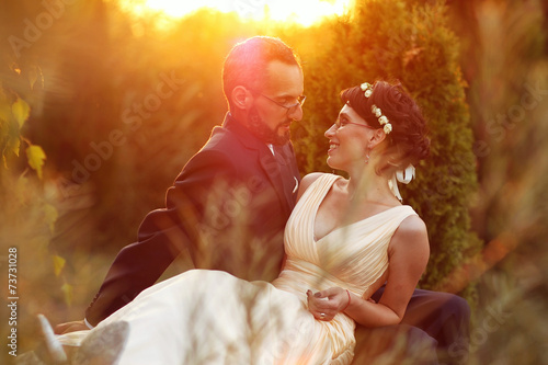 Bride and groom in a beautiful light holding hug