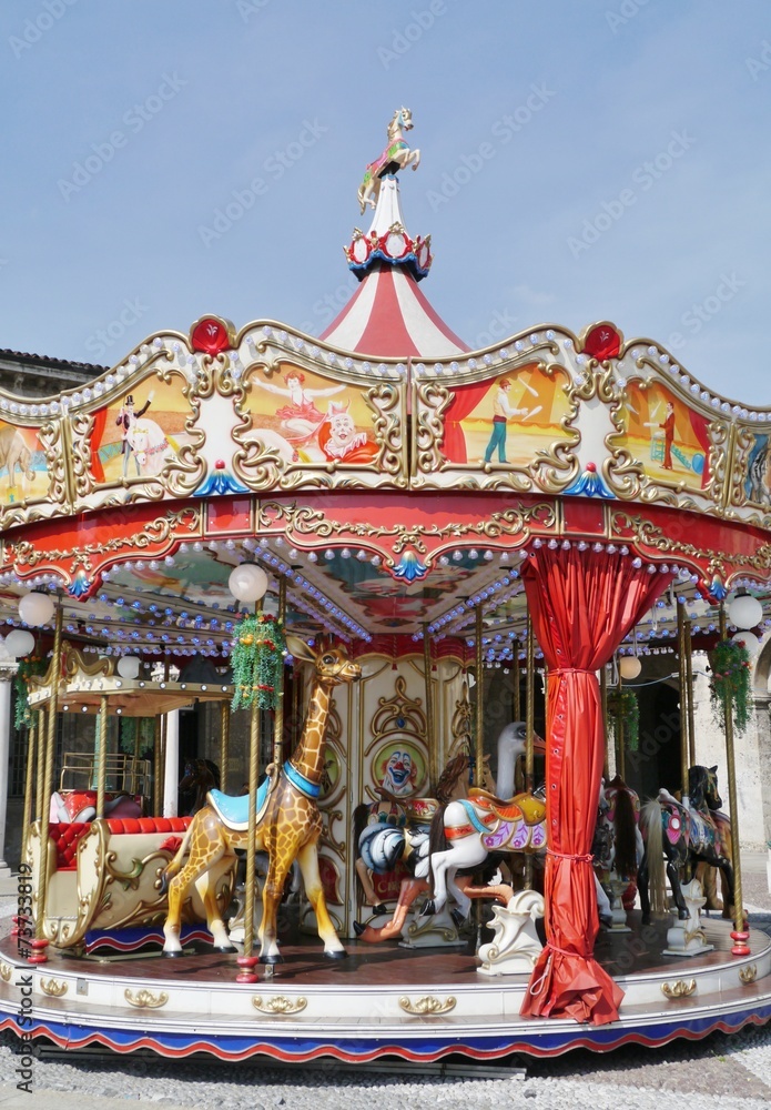 Colorful horses and a giraffe on a merry go round