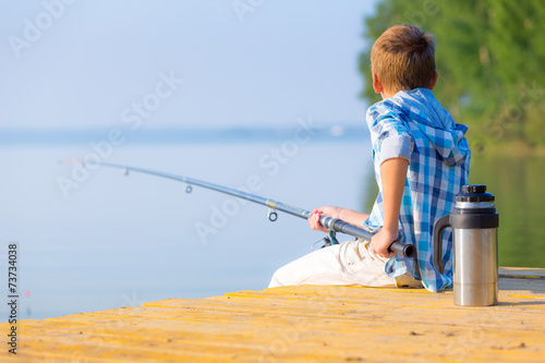 Boy in blue shirt sit on a pie