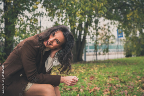 Beautiful young woman posing in a city park