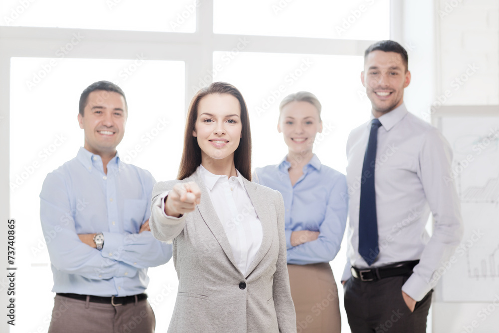 businesswoman in office pointing finger at you businesswoman in office pointing finger at you