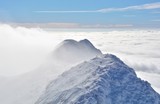 High mountains under snow and fog in the winter