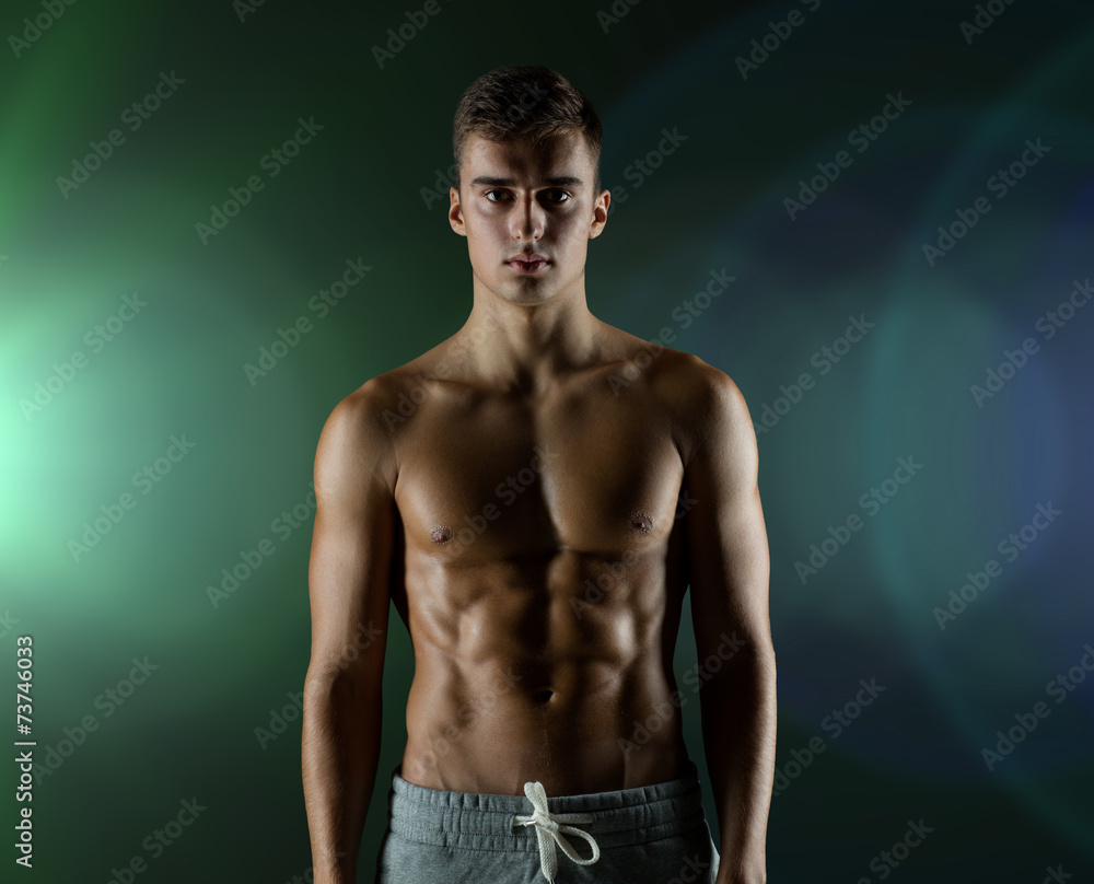 young male bodybuilder with bare muscular torso young male bodybuilder with bare muscular torso