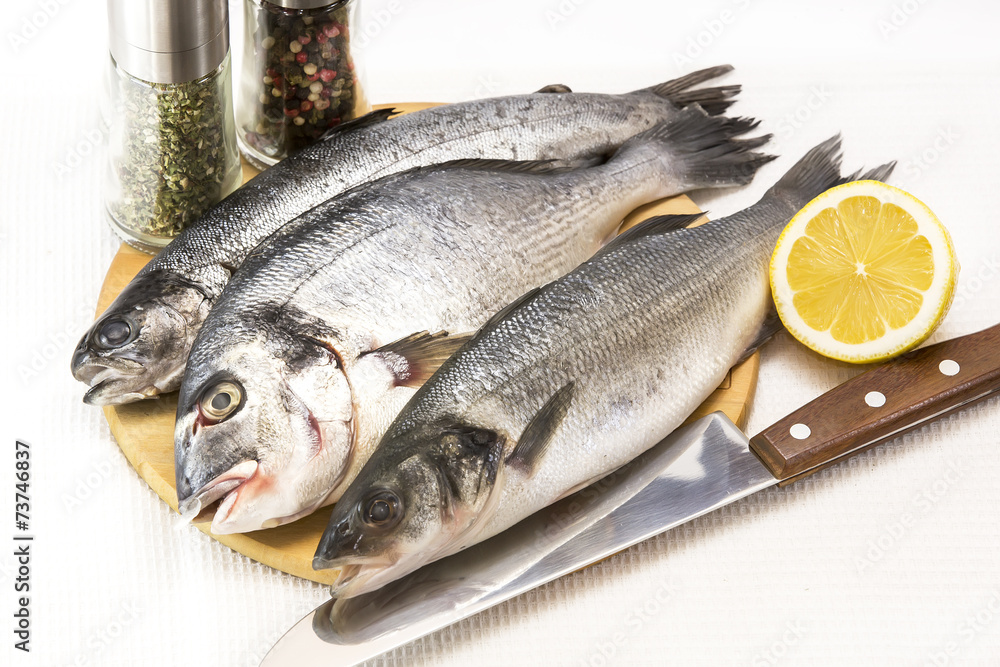 raw fish on a cutting board and knife raw fish on a cutting board and knife