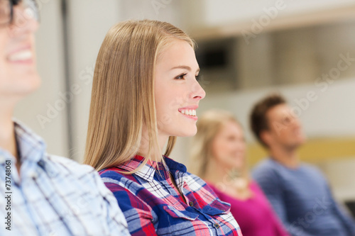 group of smiling students in lecture hall