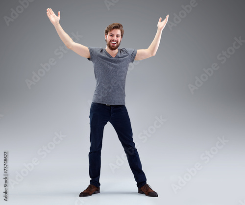Young man with beard in victory pose