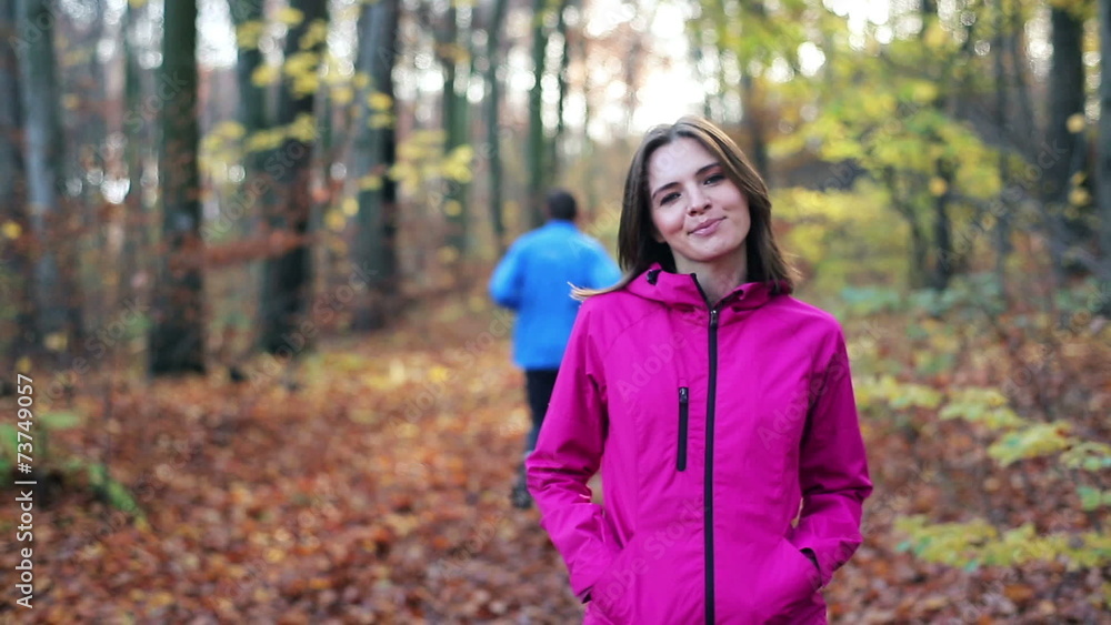 Portrait of smiling female jogger in autumn forest Portrait of smiling female jogger in autumn forest