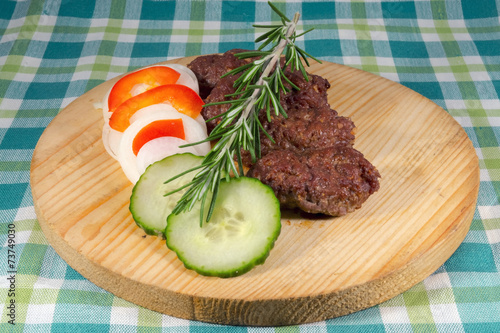 Cevapcici on a wooden dish photo