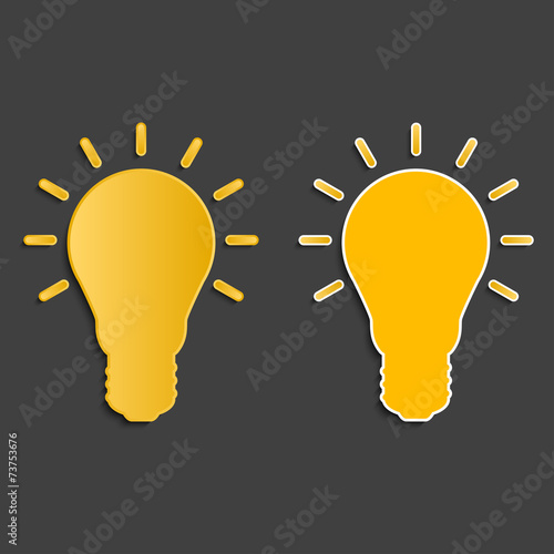 two yellow light bulbs on dark background