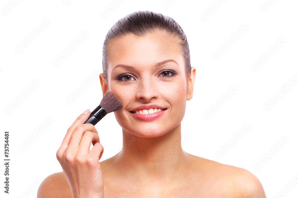 Beautiful young woman applying cosmetic paint brush Beautiful young woman applying cosmetic paint brush