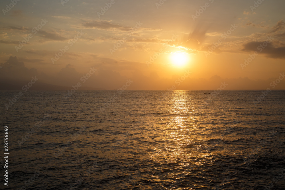 The sun rising over the sea