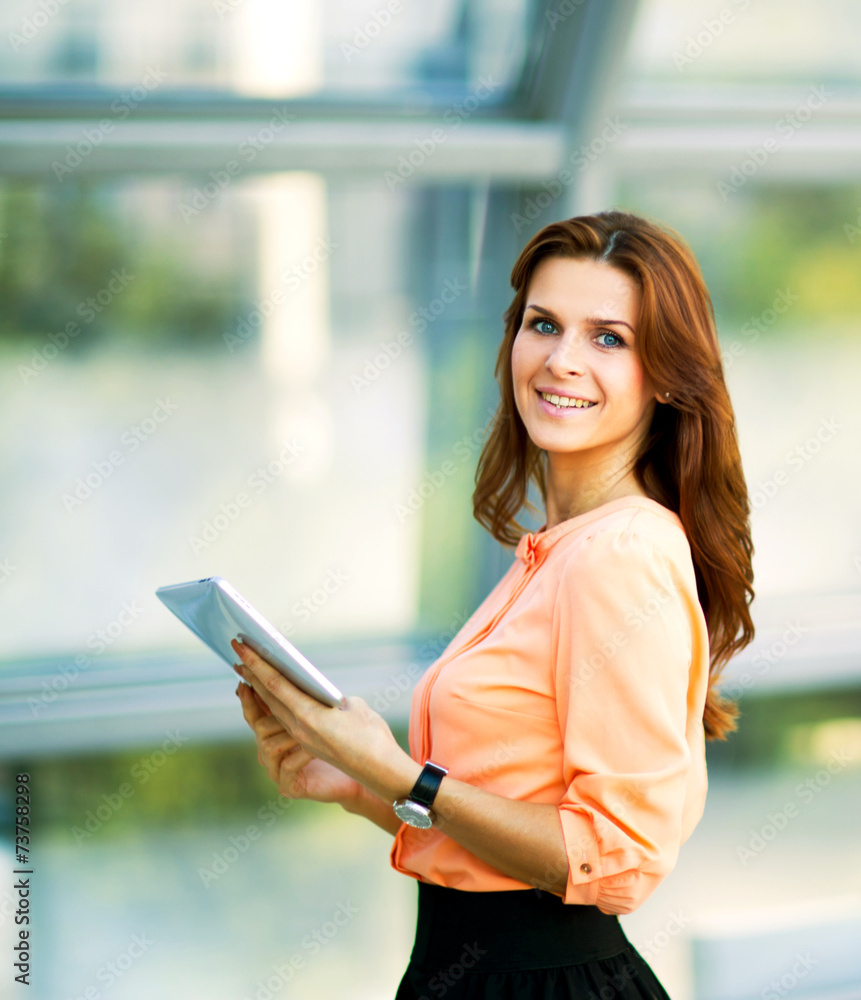 Young smiling business woman holding digital tablet Young smiling business woman holding digital tablet