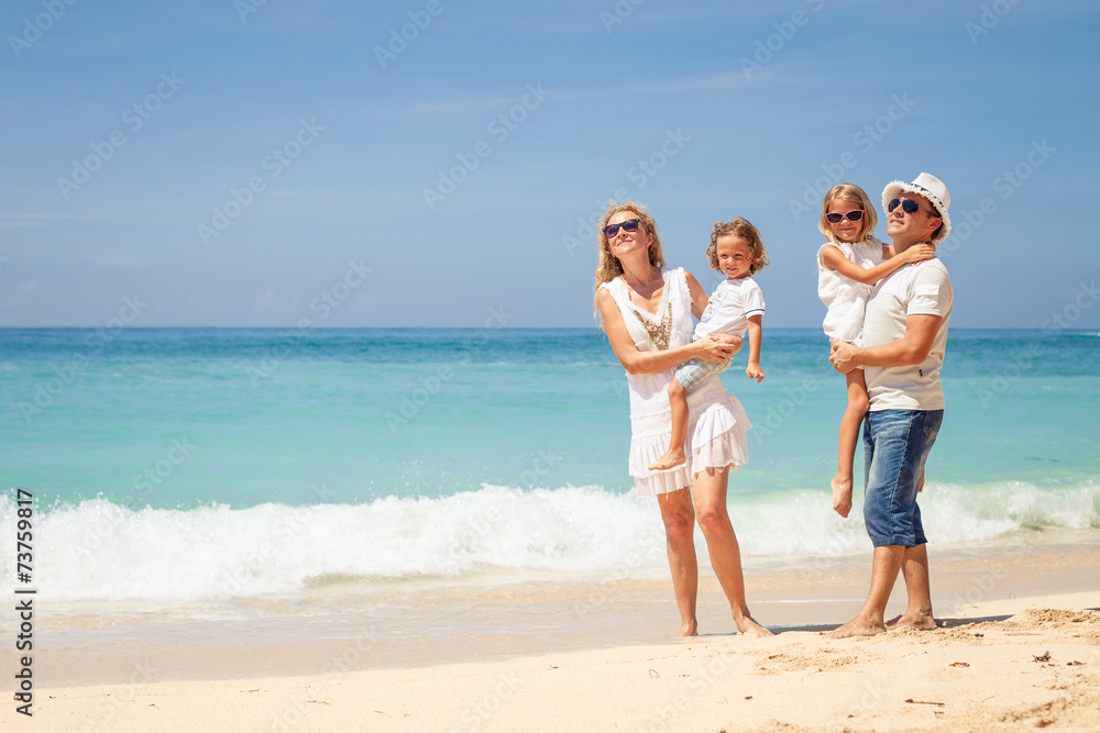 Happy family walking on the beach at the day time. Happy family walking on the beach at the day time.