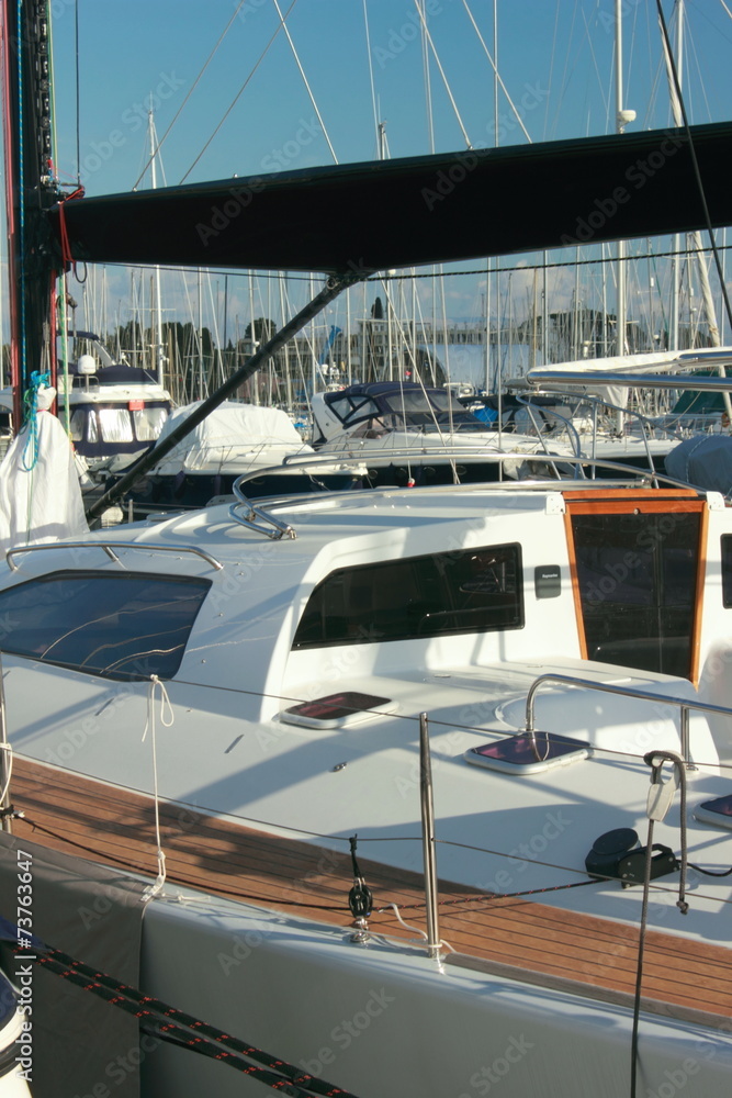 modern white sleek sail yacht boat in marina modern white sleek sail yacht boat in marina