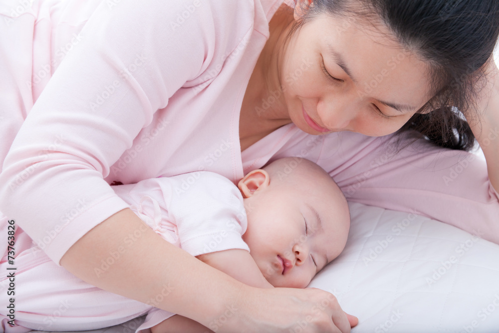 Newborn baby girl sleeping in mother arm Newborn baby girl sleeping in mother arm