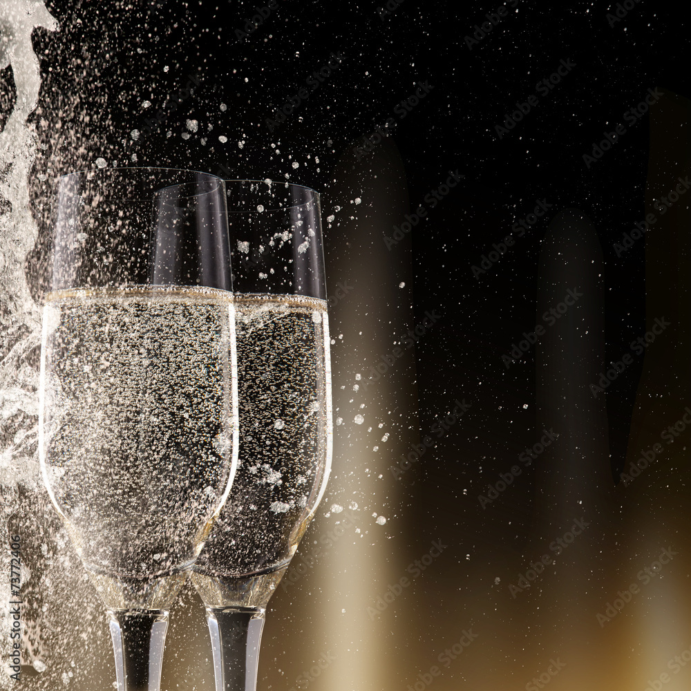 Obraz premium Champagne flutes on black background