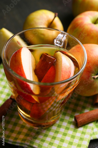 Apple cider with cinnamon sticks and fresh apples