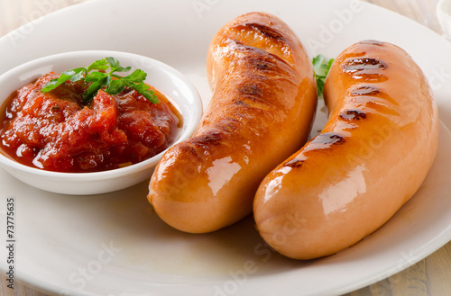 Grilled sausages with tomato sauce