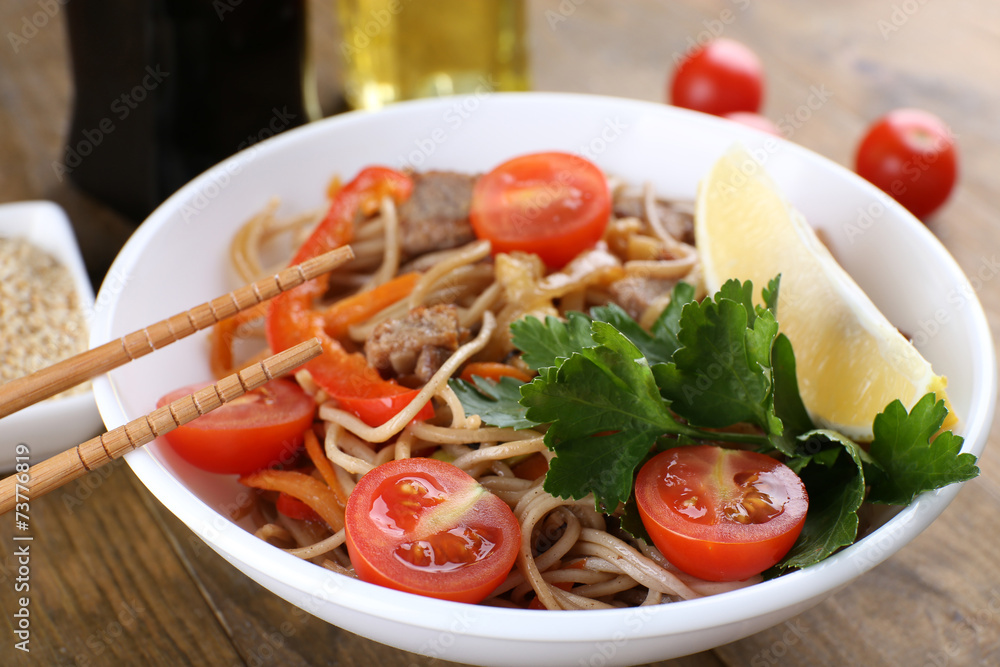 Chinese noodles with vegetables and roasted meat in bowl Chinese noodles with vegetables and roasted meat in bowl