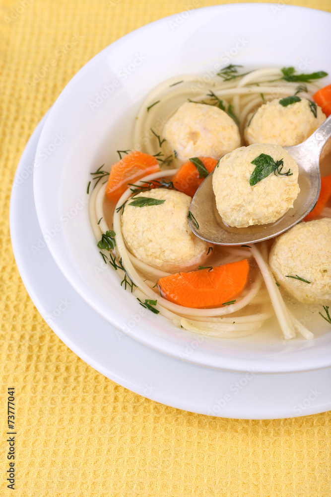 Soup with meatballs and noodles in bowl on wooden background Soup with meatballs and noodles in bowl on wooden background