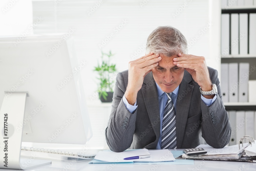 Stressed businessman with head in hands Stressed businessman with head in hands