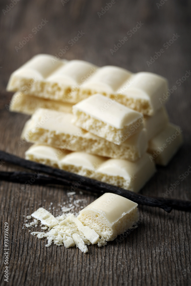 Tasty white porous chocolate with vanilla sticks