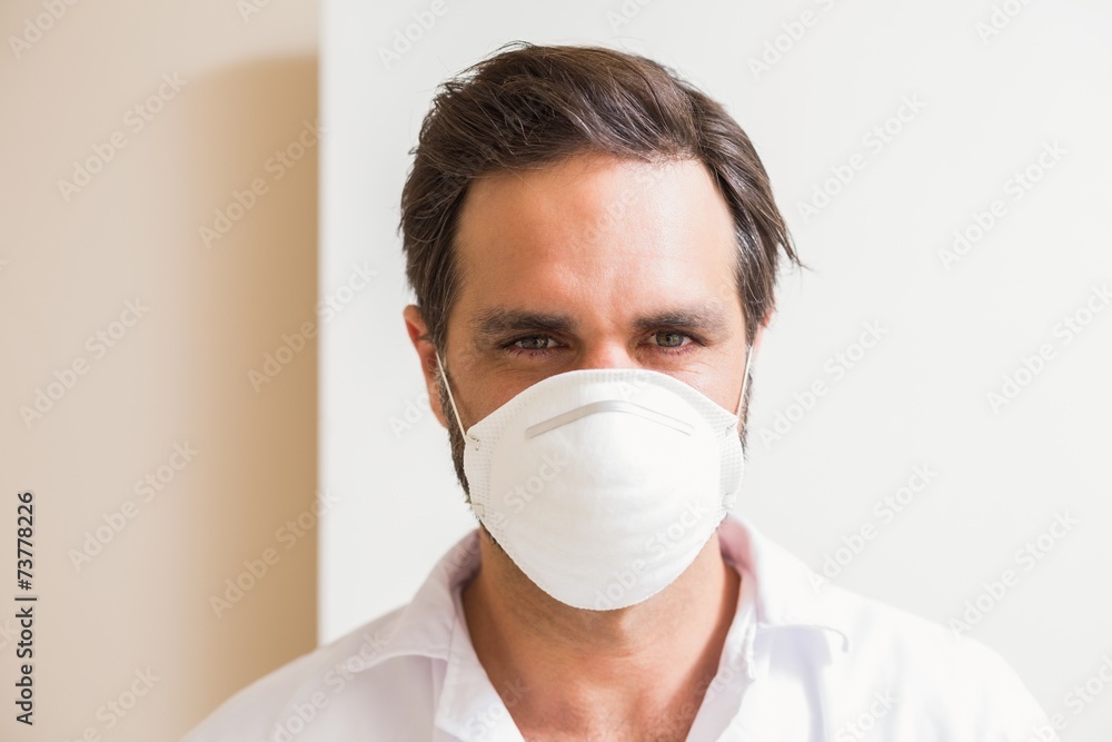 Carpenter wearing protective mask looking at camera Carpenter wearing protective mask looking at camera