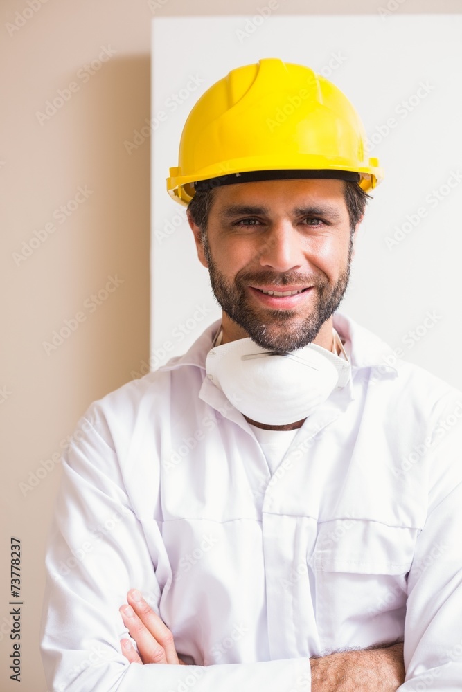 Carpenter wearing protective mask smiling at camera Carpenter wearing protective mask smiling at camera