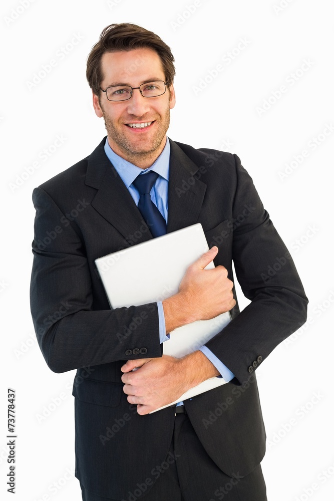 Smiling businessman holding his laptop looking at camera Smiling businessman holding his laptop looking at camera