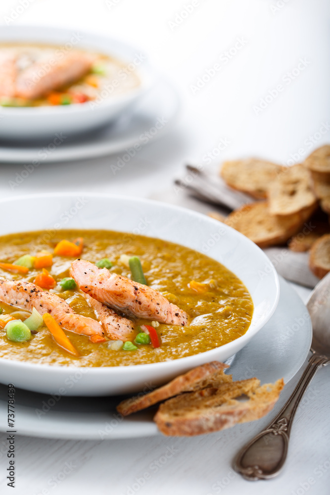 Healthy puree soup with salmon and white bread snacks